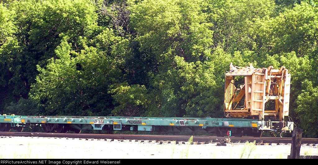 89' flat - with KERSHAW unloading rig at the head of a 20+ car work train